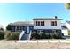 Charming two-story home with light blue door, white trim, and well-manicured landscaping at 1931 Lakeview Circle, Surfside Beach, SC 29575