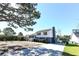 Charming two-story home features a manicured lawn, mature trees, and a long driveway for ample parking at 1931 Lakeview Circle, Surfside Beach, SC 29575