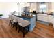 Modern kitchen with stainless steel appliances, stylish island, and wood floors at 1931 Lakeview Circle, Surfside Beach, SC 29575