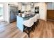 Modern kitchen with stainless steel appliances, stylish island, and wood floors at 1931 Lakeview Circle, Surfside Beach, SC 29575