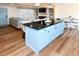 Bright open-concept kitchen featuring a spacious island with a black countertop at 1931 Lakeview Circle, Surfside Beach, SC 29575