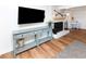 Bright living room featuring a blue console table, fireplace, and wood floors at 1931 Lakeview Circle, Surfside Beach, SC 29575