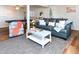 Open-concept living room features a sofa, coffee table, and stylish decor with wood floors and a gray area rug at 1931 Lakeview Circle, Surfside Beach, SC 29575