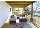 Covered porch with an outdoor seating area overlooking lush yard and a lake at 1931 Lakeview Circle, Surfside Beach, SC 29575