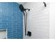 Detail of the shower with mixed white and blue tile and matte black hardware at 1931 Lakeview Circle, Surfside Beach, SC 29575