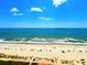 Wide angle overhead shot of sandy beach with light-blue ocean and cloudy sky backdrop at 2007 S Ocean Blvd. # 1506, Myrtle Beach, SC 29577