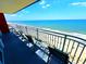 Relaxing balcony with ocean views and seating area on a sunny day at 2007 S Ocean Blvd. # 1506, Myrtle Beach, SC 29577
