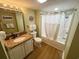 Bathroom featuring a granite topped vanity and a shower-tub combo with a curtain at 2007 S Ocean Blvd. # 1506, Myrtle Beach, SC 29577