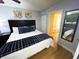 Bedroom featuring a queen bed, wood-look flooring, and connecting bathroom visible in mirror at 2007 S Ocean Blvd. # 1506, Myrtle Beach, SC 29577