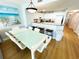 Dining area view to kitchen boasts a modern table, seating, and white cabinetry at 2007 S Ocean Blvd. # 1506, Myrtle Beach, SC 29577