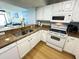 A well-equipped kitchen with stainless steel appliances and white cabinetry at 2007 S Ocean Blvd. # 1506, Myrtle Beach, SC 29577