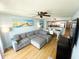 Open-concept living area featuring a comfortable gray sofa and a view into the kitchen and dining area at 2007 S Ocean Blvd. # 1506, Myrtle Beach, SC 29577