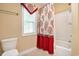 Bathroom featuring coral-themed decor, a window, and a shower-tub combination at 210 Natures View Circle, Pawleys Island, SC 29585