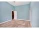 Bedroom with neutral carpet, base molding, and an ensuite bathroom at 210 Natures View Circle, Pawleys Island, SC 29585