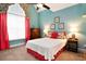 Comfortable bedroom with light teal walls, carpeted floor, and bright window light at 210 Natures View Circle, Pawleys Island, SC 29585