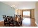 Elegant dining area with hardwood floors, chandelier, and ample natural light at 210 Natures View Circle, Pawleys Island, SC 29585