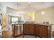 Open-concept kitchen with stainless steel dishwasher and island seating overlooking the dining room at 210 Natures View Circle, Pawleys Island, SC 29585