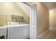 Laundry room featuring a washer, dryer, sink, and tiled floor at 210 Natures View Circle, Pawleys Island, SC 29585