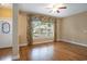 Cozy living room featuring hardwood floors, a large window, and neutral paint colors at 210 Natures View Circle, Pawleys Island, SC 29585