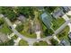 An aerial view displays a quaint home with lush landscaping, surrounded by neighboring properties and a winding street at 216 Deer Trace Circle, Myrtle Beach, SC 29588