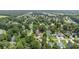 An aerial view reveals a home with mature trees, nestled in a neighborhood near a tranquil pond at 216 Deer Trace Circle, Myrtle Beach, SC 29588