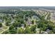 Aerial view of a home with a screened pool and lush landscaping, surrounded by mature trees and neighboring houses at 216 Deer Trace Circle, Myrtle Beach, SC 29588