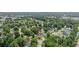 Aerial view showcases a home nestled among mature trees, with a view of a pond and the surrounding neighborhood at 216 Deer Trace Circle, Myrtle Beach, SC 29588