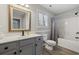 Bathroom featuring a vanity with a grey cabinet and bathtub with shower at 216 Deer Trace Circle, Myrtle Beach, SC 29588