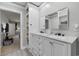 Bathroom featuring a vanity with white cabinets, double sinks, and a mirror at 216 Deer Trace Circle, Myrtle Beach, SC 29588