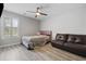 Bright bedroom featuring a bed, couch, and a ceiling fan above hardwood flooring at 216 Deer Trace Circle, Myrtle Beach, SC 29588