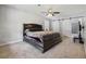 Bedroom featuring a large bed, carpet flooring, and a barn door leading to the bathroom at 216 Deer Trace Circle, Myrtle Beach, SC 29588