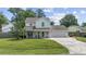 Charming two-story home boasts a manicured lawn, an attached garage, and a welcoming covered front porch with seating at 216 Deer Trace Circle, Myrtle Beach, SC 29588