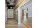 Hallway features wood accent wall and floors. Offers a glimpse into the home's open layout and airy living spaces at 216 Deer Trace Circle, Myrtle Beach, SC 29588