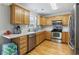 Well-lit kitchen featuring wooden cabinets, stainless steel appliances, and hardwood floors at 216 Deer Trace Circle, Myrtle Beach, SC 29588