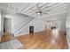 Open-concept living room with hardwood floors, white stairs and neutral paint throughout at 216 Deer Trace Circle, Myrtle Beach, SC 29588