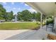 Inviting covered front porch with seating, offering views of the manicured lawn and quiet residential street at 216 Deer Trace Circle, Myrtle Beach, SC 29588