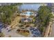 Stunning aerial view of community amenities including a pool, clubhouse, and lake surrounded by lush greenery at 2504 Heritage Loop # 2504, Myrtle Beach, SC 29577
