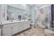 Well-lit bathroom with double vanity, large mirror, and combination tub and shower for convenience at 2504 Heritage Loop # 2504, Myrtle Beach, SC 29577
