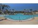 Large community pool featuring palm trees, lounge chairs, and a splash area for Gathering fun and relaxation at 2504 Heritage Loop # 2504, Myrtle Beach, SC 29577