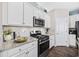 Close up of a modern kitchen with stainless steel appliances, granite countertops and white cabinetry at 2504 Heritage Loop # 2504, Myrtle Beach, SC 29577