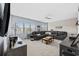 Comfortable living room with plush seating, large windows, ceiling fan, and modern decor at 2504 Heritage Loop # 2504, Myrtle Beach, SC 29577