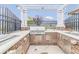 Well-equipped outdoor kitchen with a built-in grill, sink, and brick accents for alfresco dining at 2504 Heritage Loop # 2504, Myrtle Beach, SC 29577
