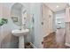 Stylish powder room with pedestal sink, decorative mirror, and attractive paint color scheme at 2504 Heritage Loop # 2504, Myrtle Beach, SC 29577