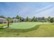 Community putting green with manicured turf, palm trees, and a gazebo for recreational enjoyment at 2504 Heritage Loop # 2504, Myrtle Beach, SC 29577