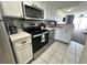 Well-lit kitchen with white cabinets, stainless steel appliances, and a tile backsplash at 2701 S Ocean Blvd. # 720, North Myrtle Beach, SC 29582