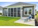 Beautiful backyard featuring a screened-in porch and a patio with lawn chairs at 314 Bumble Circle, Murrells Inlet, SC 29576