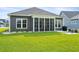 Lush backyard with a screened-in porch, patio, and manicured lawn perfect for outdoor living at 314 Bumble Circle, Murrells Inlet, SC 29576