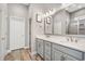 Bright bathroom with tile floors, a glass enclosed shower and vanity with double sinks at 314 Bumble Circle, Murrells Inlet, SC 29576