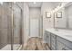Bright bathroom with tile floors, a glass enclosed shower and vanity with double sinks at 314 Bumble Circle, Murrells Inlet, SC 29576