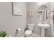 Charming powder room with pedestal sink and stylish patterned tile flooring at 314 Bumble Circle, Murrells Inlet, SC 29576